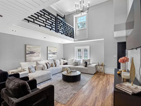 a living room with furniture and a chandelier