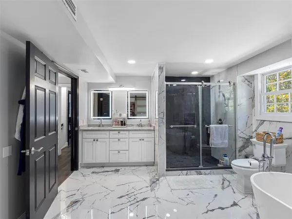 a spacious bedroom with a bed and a desk