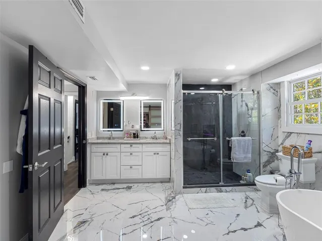 a spacious bedroom with a bed and a desk