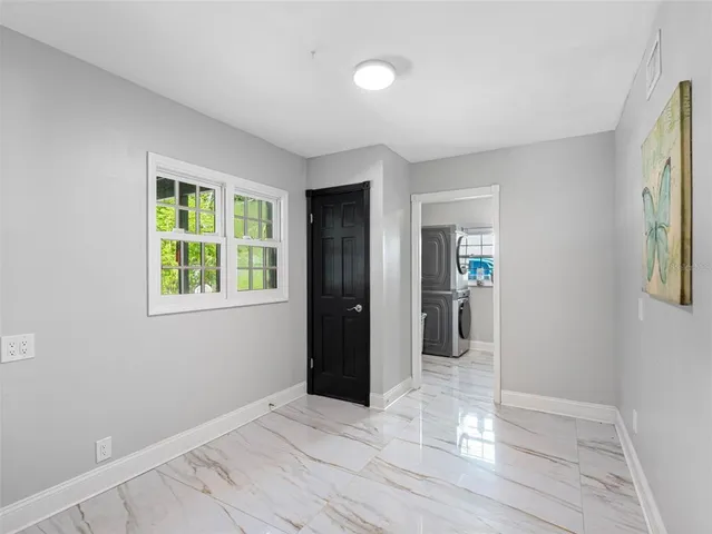 a view of a house with pool and chairs