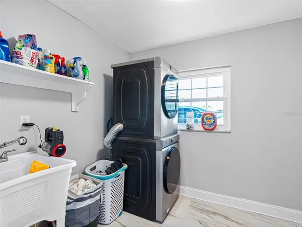 a view of a backyard with table and chairs under an umbrella