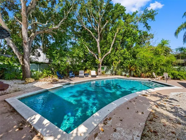 an aerial view of a house with yard swimming pool and outdoor seating