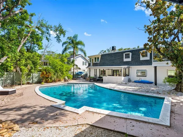 an aerial view of residential houses with outdoor space and boats