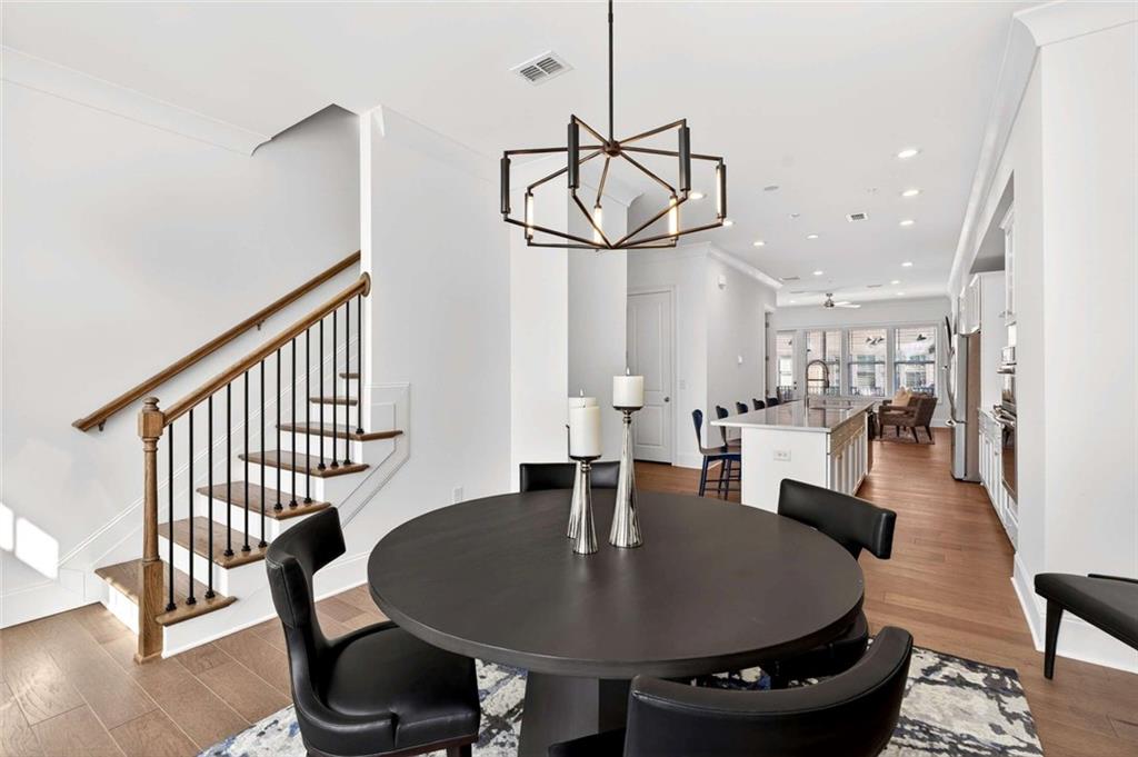 6786 Encore Boulevard Atlanta, GA 30328 - Photo 11 of 31 a dining room with furniture a rug and wooden floor