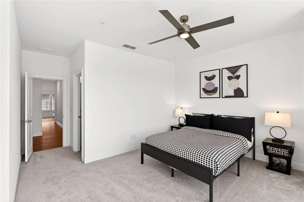 6786 Encore Boulevard Atlanta, GA 30328 - Photo 16 of 31 a bedroom with a bed and a chandelier