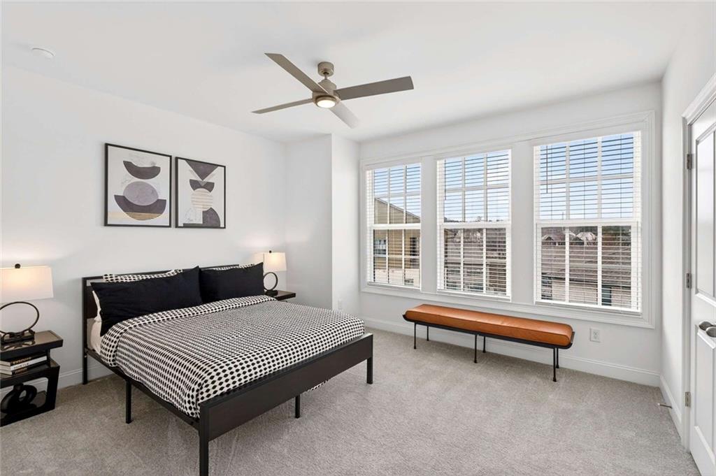 6786 Encore Boulevard Atlanta, GA 30328 - Photo 17 of 31 a bedroom with a bed and wooden floor