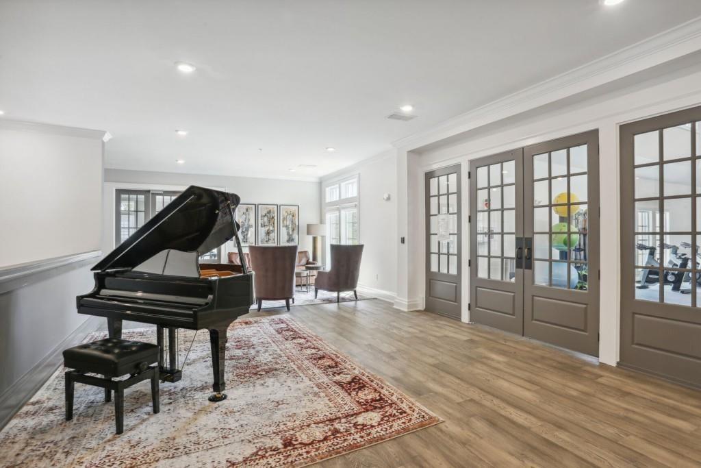 6786 Encore Boulevard Atlanta, GA 30328 - Photo 26 of 31 a living room with furniture a piano and wooden floor