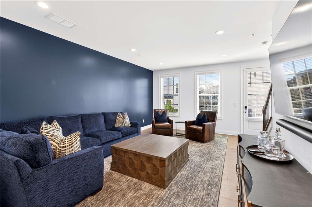 6786 Encore Boulevard Atlanta, GA 30328 - Photo 3 of 31 a living room with furniture and a wooden floor