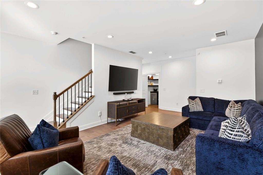 6786 Encore Boulevard Atlanta, GA 30328 - Photo 4 of 31 a living room with furniture and a flat screen tv
