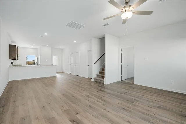 a view of a kitchen with a sink and dishwasher cabinet with wooden floor