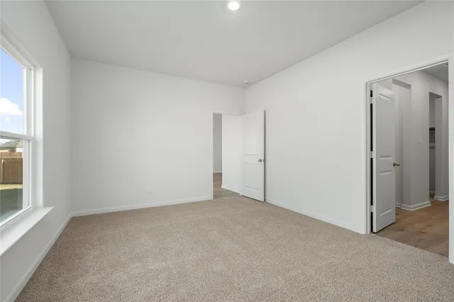 a view of room with wooden floor and ceiling fan