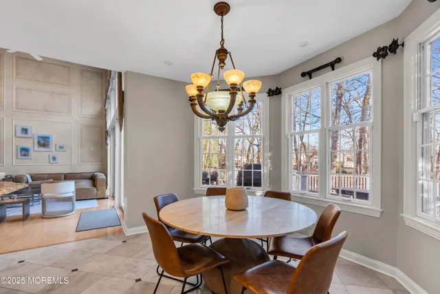 a kitchen with stainless steel appliances granite countertop a sink a stove and a wooden floors