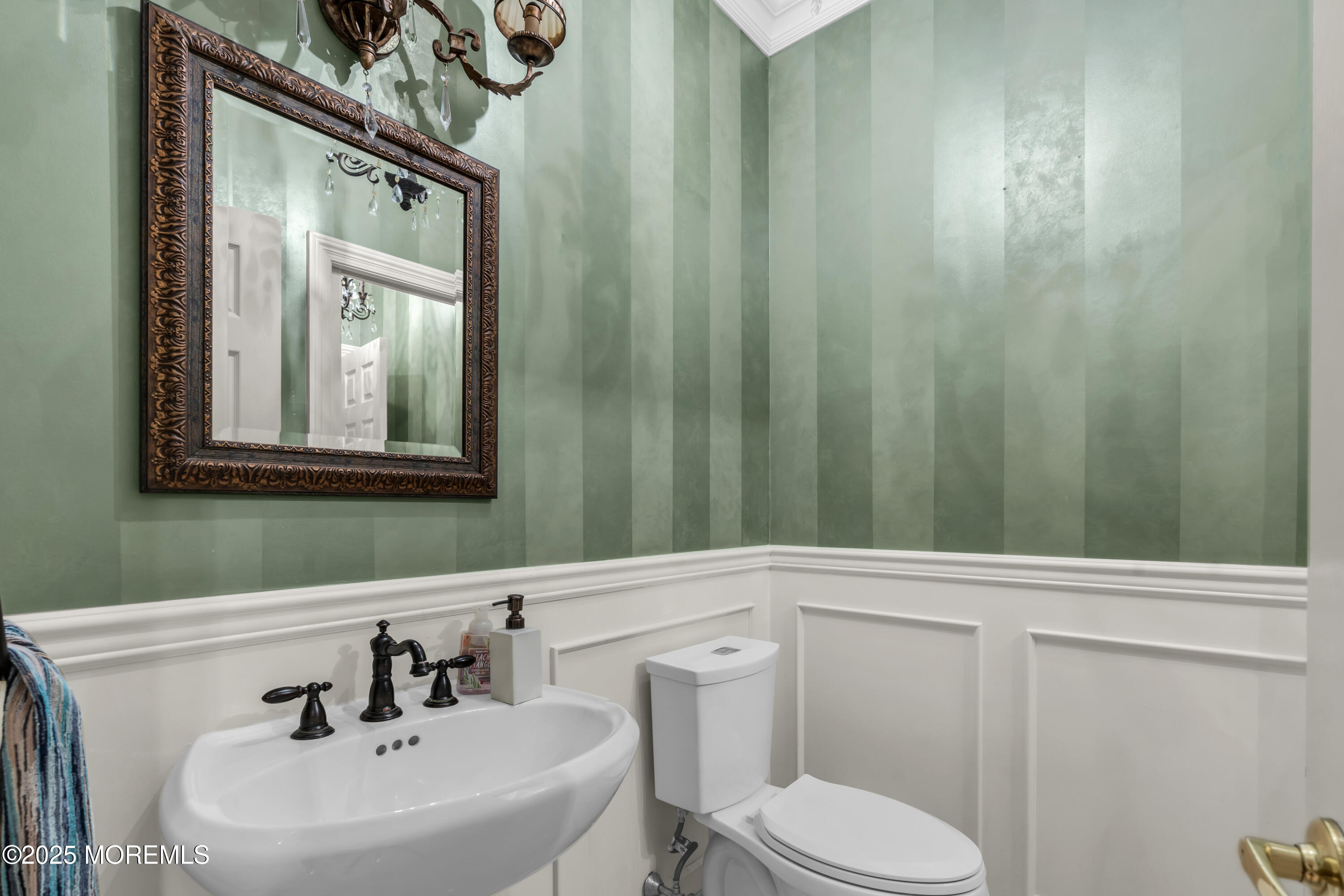 26 Bruns Road Allenhurst, NJ 07711 - Photo 37 of 82 a bathroom with a sink a toilet and mirror