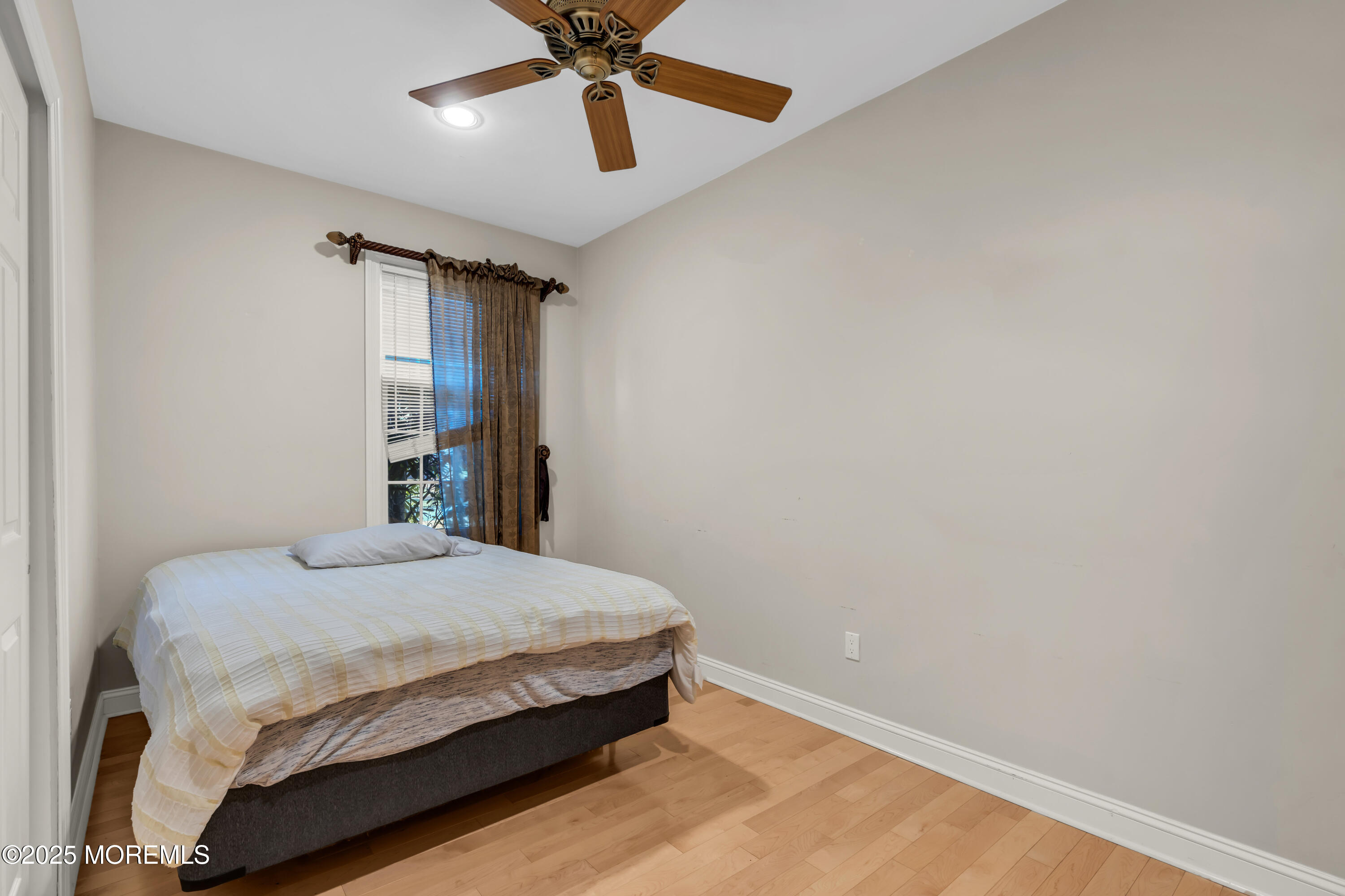 26 Bruns Road Allenhurst, NJ 07711 - Photo 41 of 82 a bedroom with a bed and a chandelier