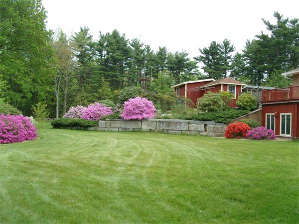 338 Ware Corner Road Oakham, MA 01068 - Photo 11 of 20 a front view of a house with backyard and garden