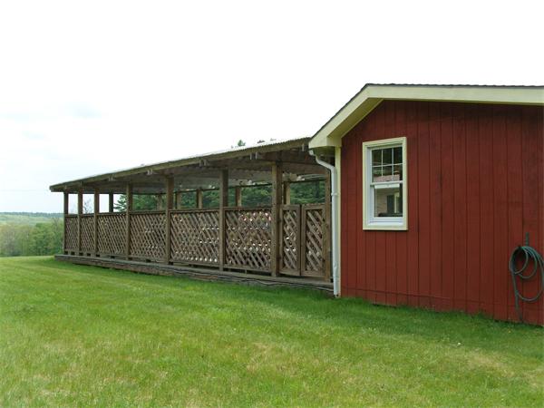 338 Ware Corner Road Oakham, MA 01068 - Photo 9 of 20 a view of a backyard with potted plants and wooden fence