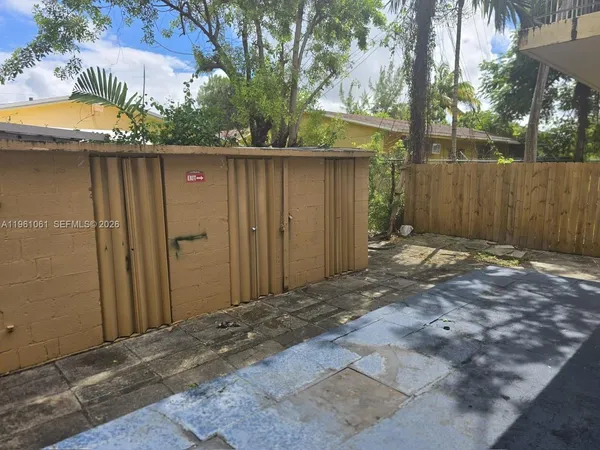 a view of backyard of house and trees