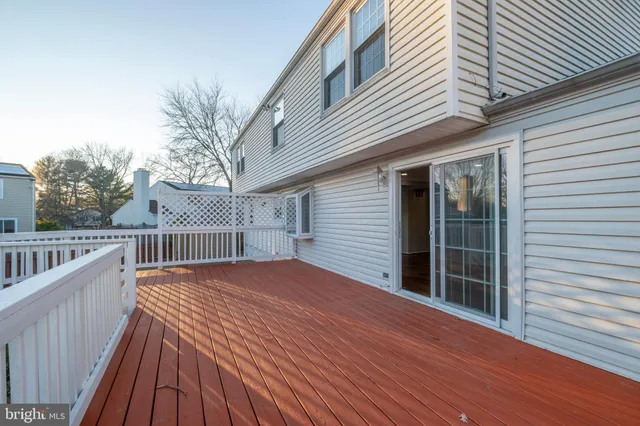 a kitchen with refrigerator and chairs