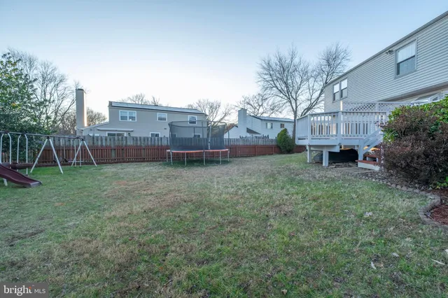 a kitchen with granite countertop a refrigerator and cabinets