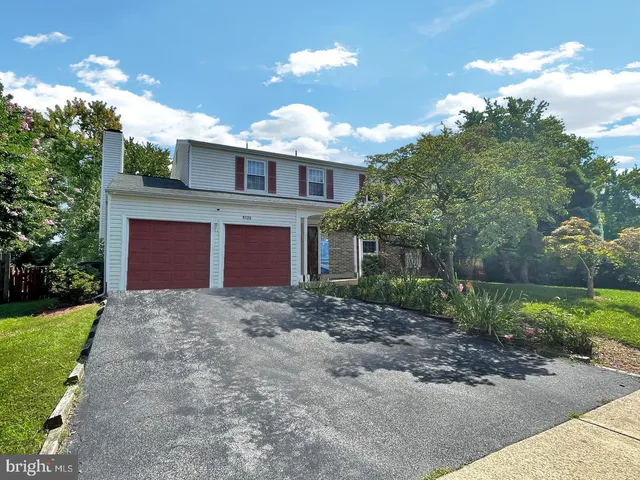 a view of a house with a yard and pathway