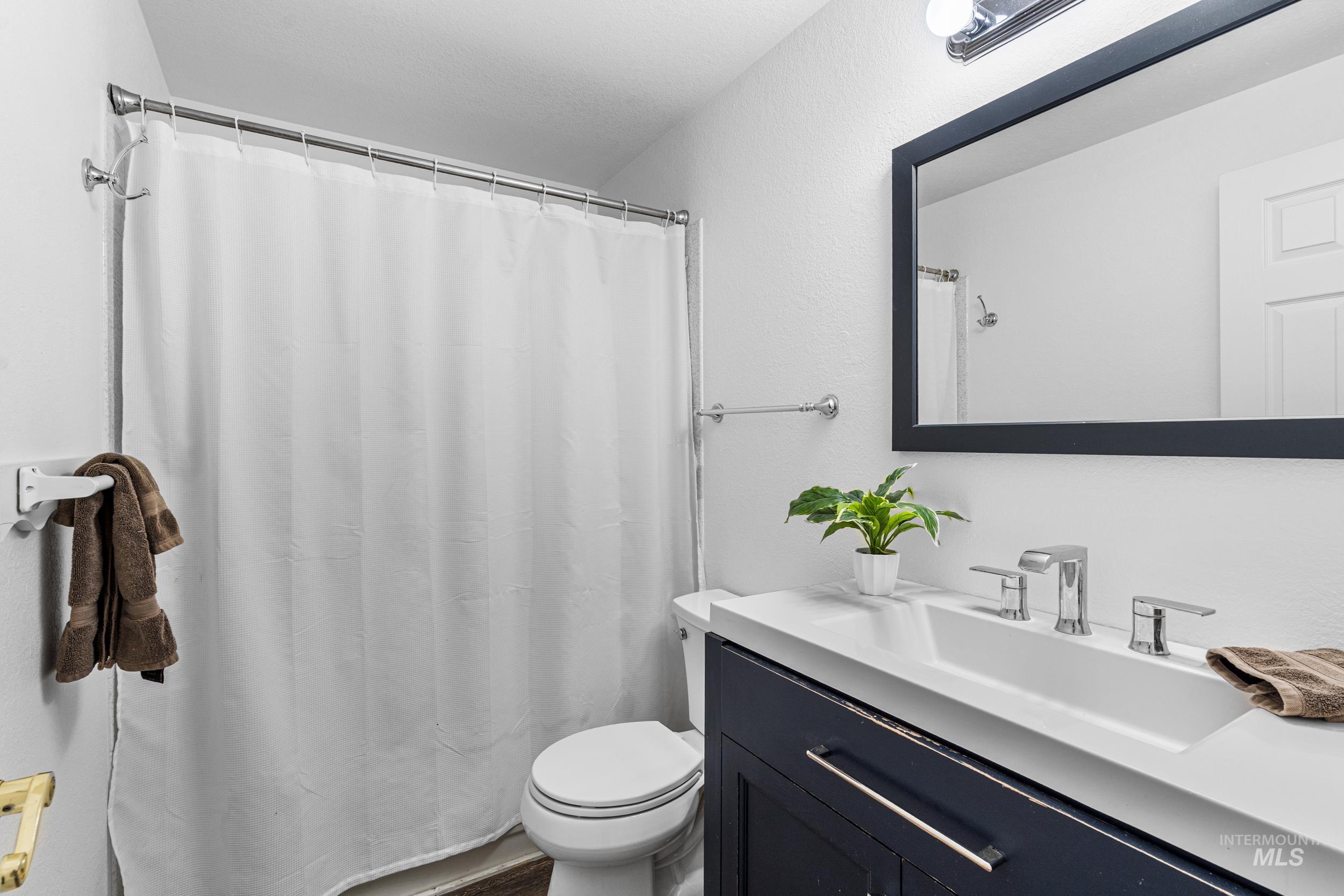 1212 East Ustick Road Caldwell, ID 83607 - Photo 23 of 50 Bathroom featuring vanity and a shower with shower curtain