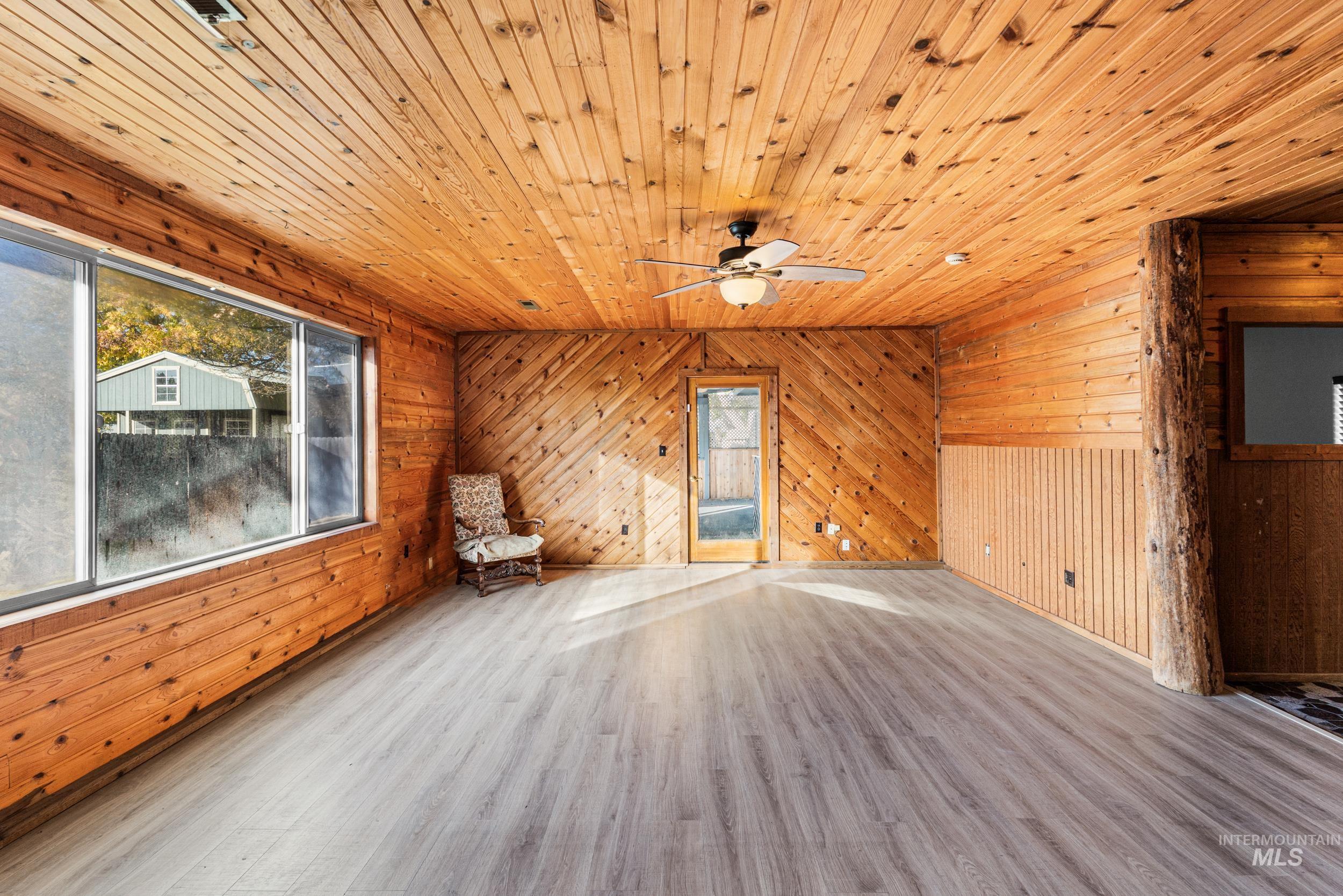1212 East Ustick Road Caldwell, ID 83607 - Photo 26 of 50 Unfurnished room with wooden walls, wood finished floors, wooden ceiling, healthy amount of natural light, and a ceiling fan