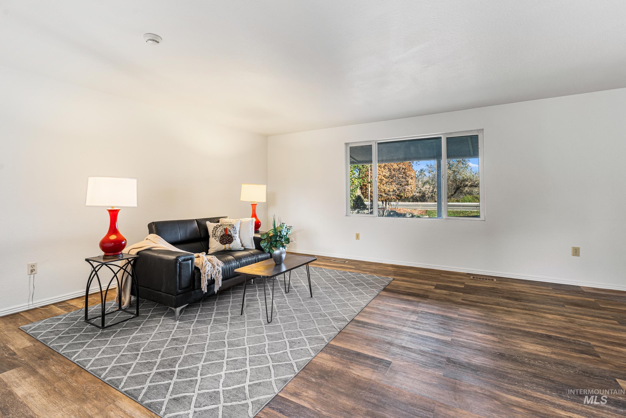 1212 East Ustick Road Caldwell, ID 83607 - Photo 9 of 50 Living room featuring dark wood-style floors