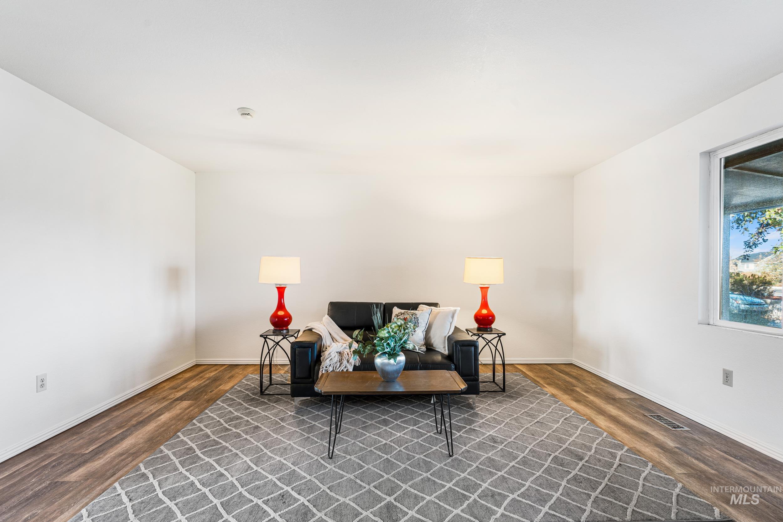 1212 East Ustick Road Caldwell, ID 83607 - Photo 10 of 50 Sitting room featuring dark wood-style flooring and baseboards