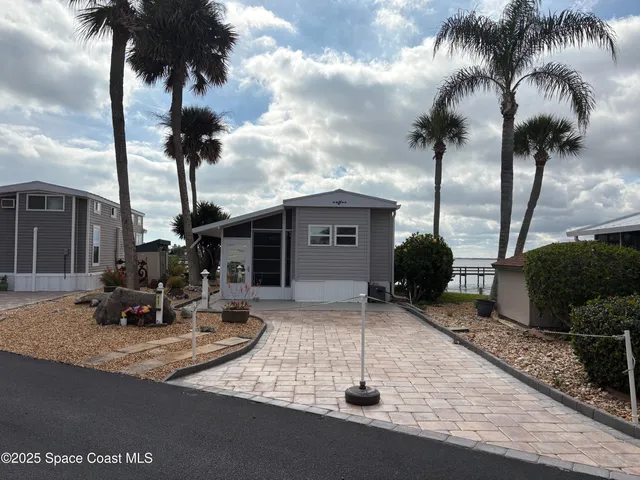 a group of people sitting in front of a house