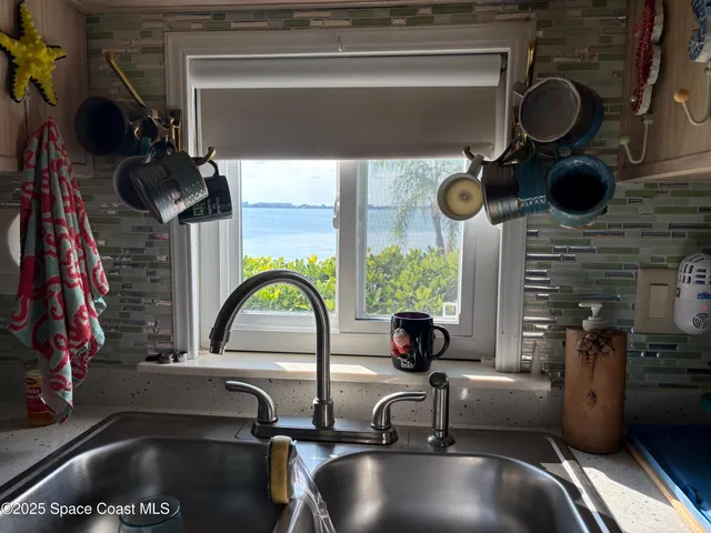 a living room with furniture a chandelier and a flat screen tv