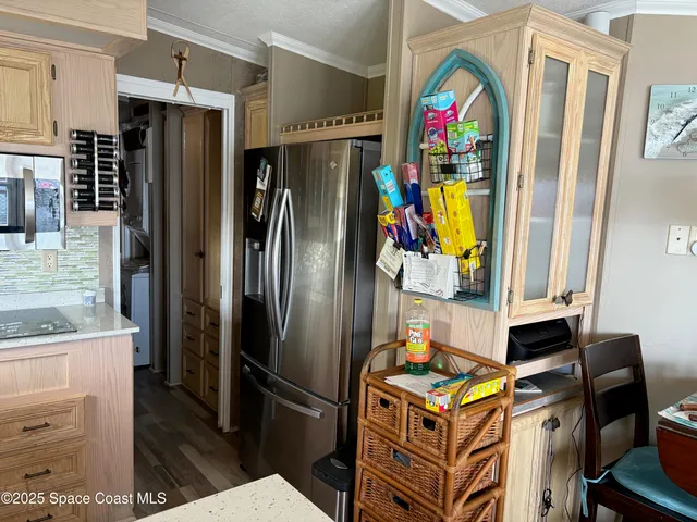 a living room with furniture a flat screen tv and a window