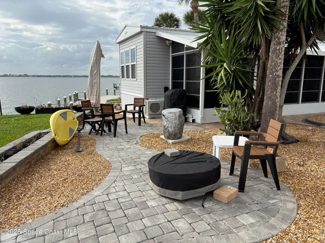 a view of swimming pool with lounge chair and dinning table under an umbrella