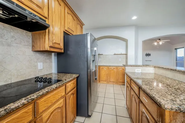a kitchen with stainless steel appliances granite countertop a sink and a stove