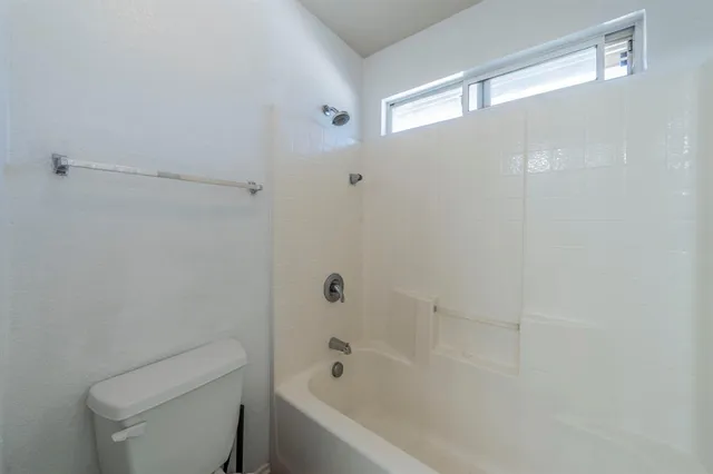 a bathroom with a bathtub and toilet