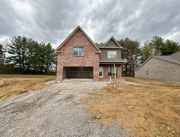a front view of a house with yard and garage