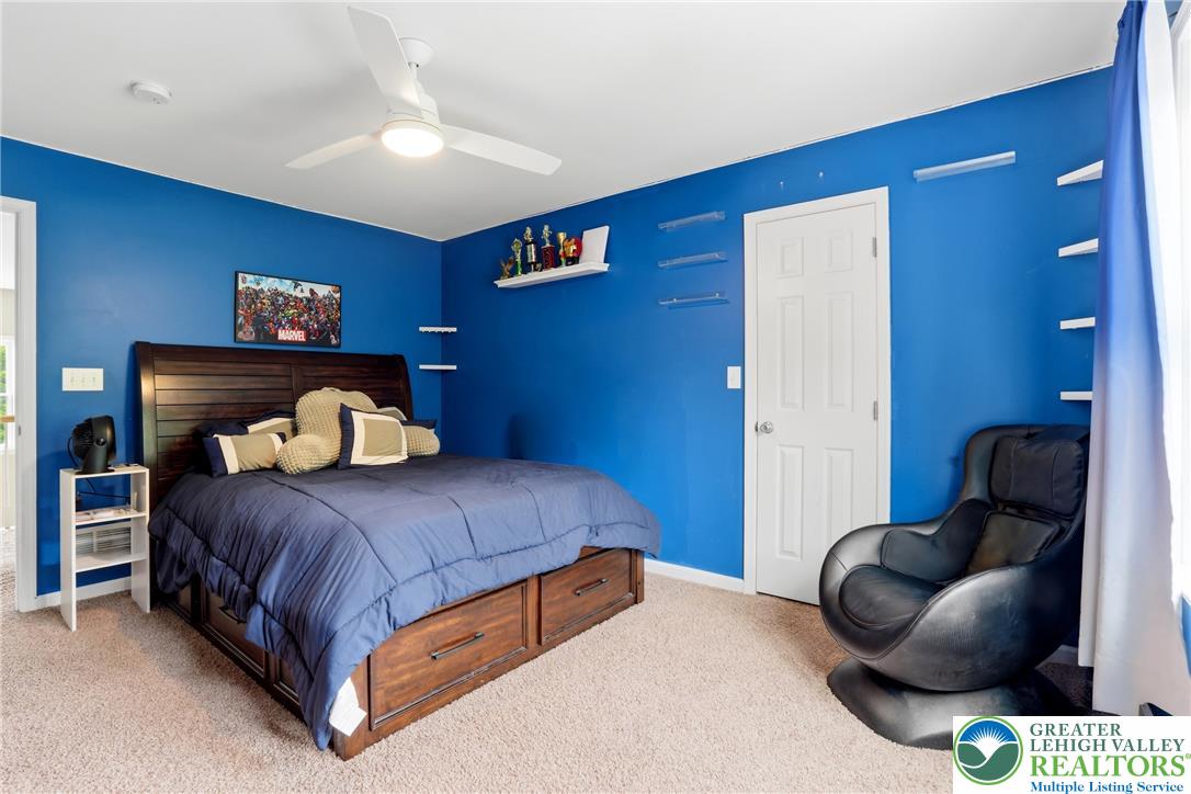 1212 Miller Road Wind Gap, PA 18091 - Photo 44 of 72 A comfortable bedroom features carpet flooring and a ceiling fan, creating a welcoming and functional retreat.