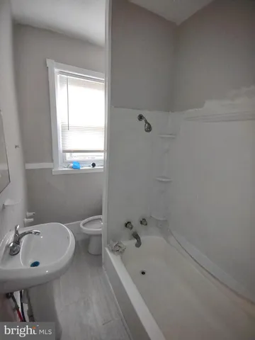 a bathroom with a sink a toilet and bathtub