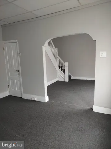 a view of an empty room with a stairs