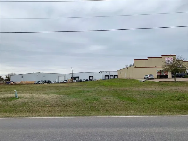 a view of a big yard with large trees