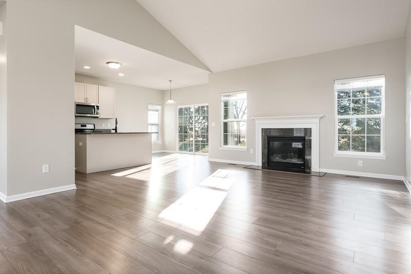104 Reston Court Sycamore, IL 60178 - Photo 12 of 41 a view of an empty room with window and wooden floor