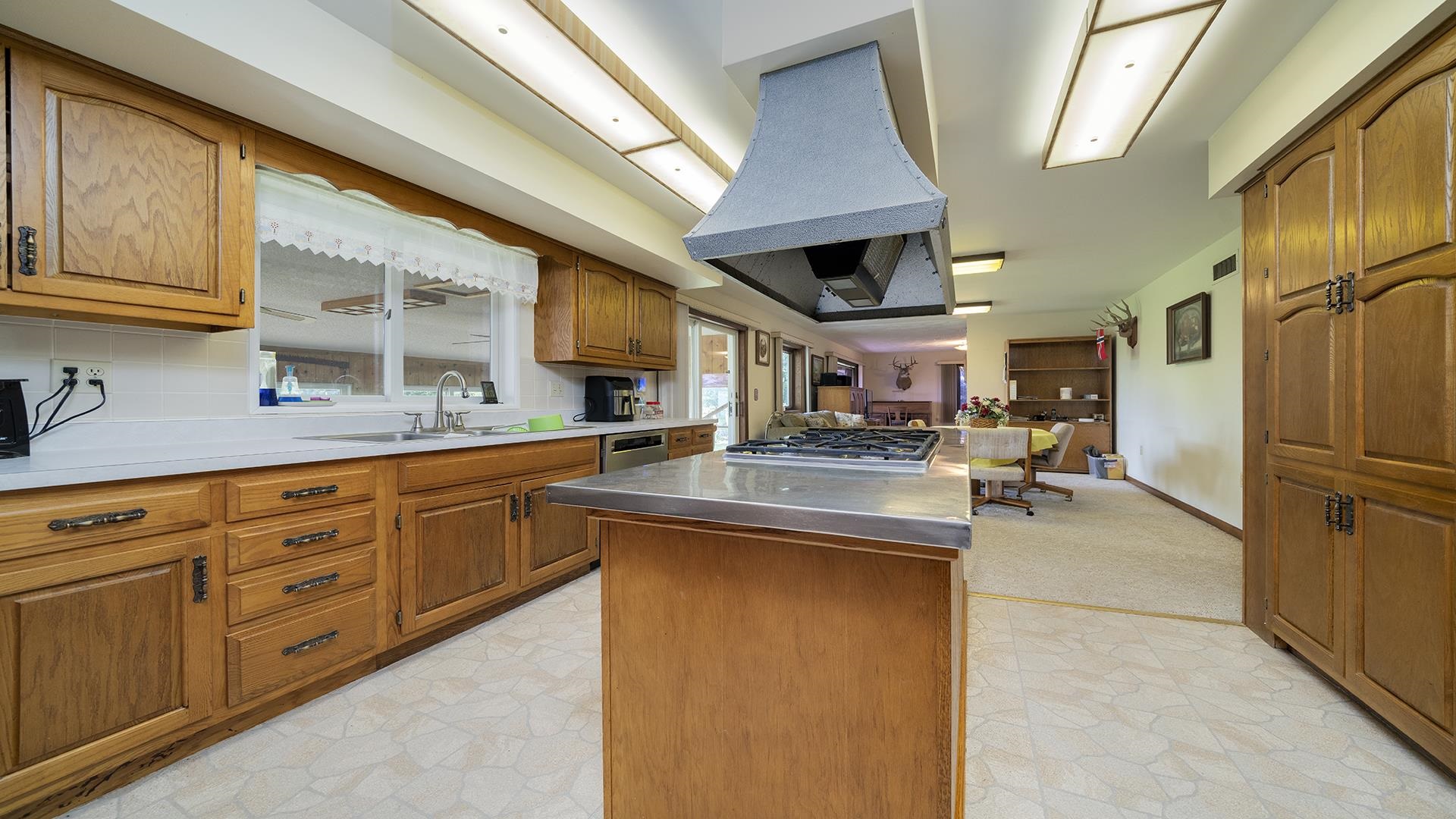 10245 West Penn Corner Road Polo, IL 61064 - Photo 12 of 48 a kitchen with stainless steel appliances granite countertop a refrigerator a sink dishwasher a stove and white countertops with wooden floor
