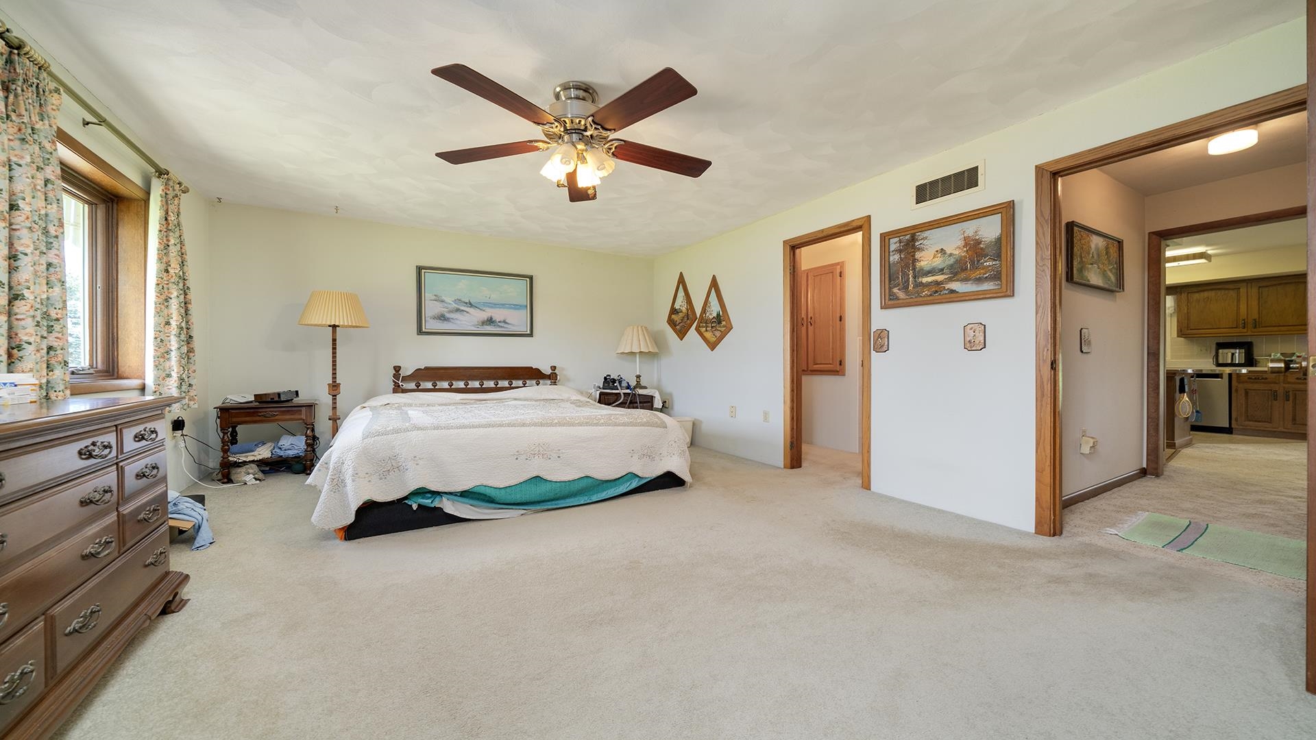 10245 West Penn Corner Road Polo, IL 61064 - Photo 20 of 48 a spacious bedroom with a bed and a chandelier