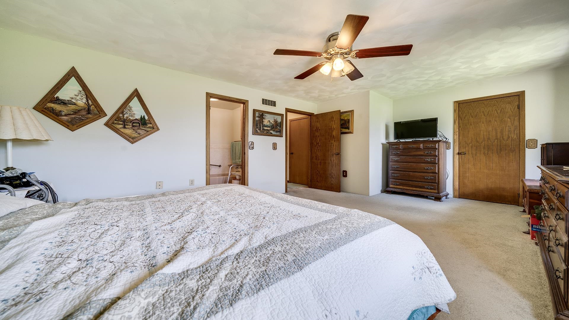 10245 West Penn Corner Road Polo, IL 61064 - Photo 21 of 48 a bedroom with a bed and a chandelier