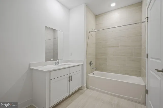 a bathroom with a bathtub and a sink