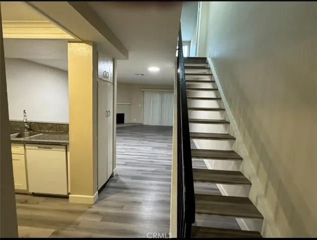 a view of a hallway with wooden floor and entryway