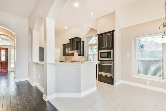 a kitchen with stainless steel appliances a refrigerator and a stove top oven