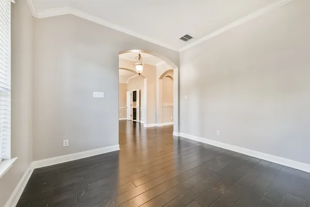 a view of a room with wooden floor