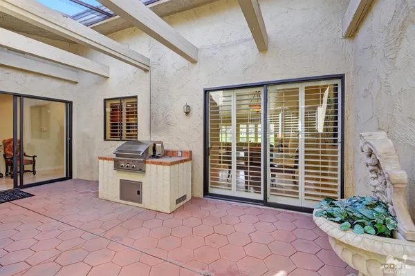 a view of a kitchen with a sink and a large window