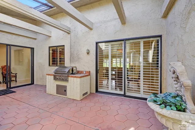 a view of a kitchen with a sink and a large window