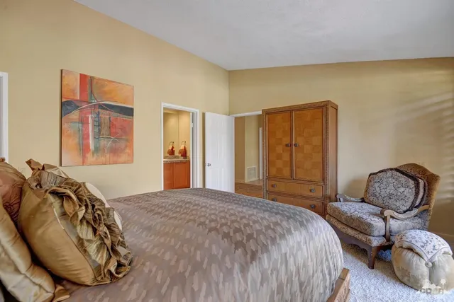 a bedroom with a bed chair and window